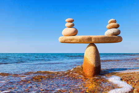 Symbolic scale of the stones on sea background closeup. Concept of harmony and balance. work-life, emotional balance