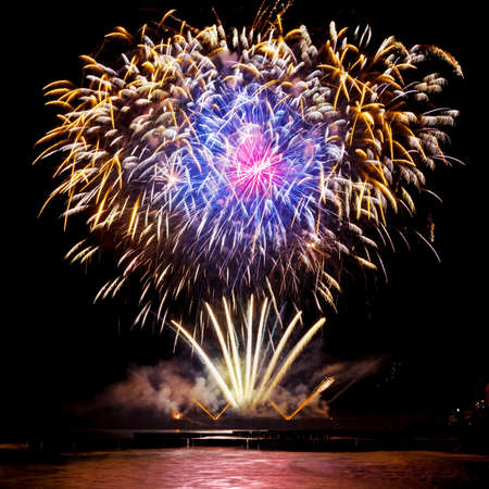 Festive fireworks of golden color on a black sky background