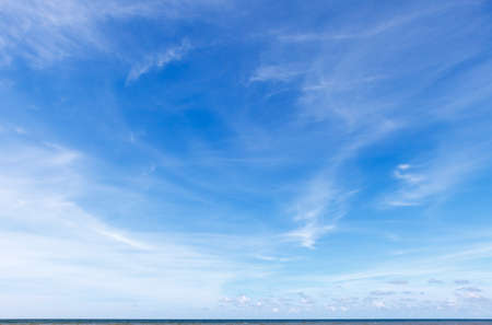Beautiful blue sky over the sea with translucent, white, Cirrus clouds. The horizon lineの写真素材