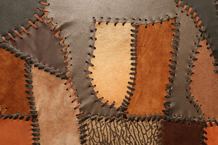 Pieces of genuine leather of different sizes and textures sewn togetherの写真素材