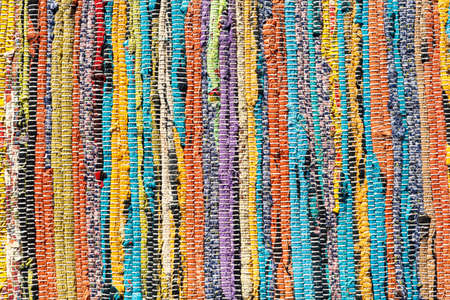 Multicolored handmade floor rug made out of recycled cotton rags. close-up, background image, textureの写真素材