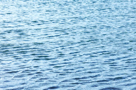surface of the water blue. background image, texture with ripples sea. Soft focus, selective focusの写真素材