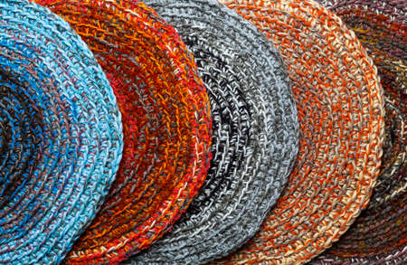 Several round, colored mats crocheted from thick threads. top viewの写真素材