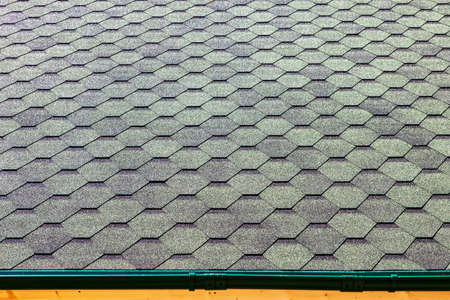 the roof of the house is covered with soft tiles, bitumen shinglesの写真素材
