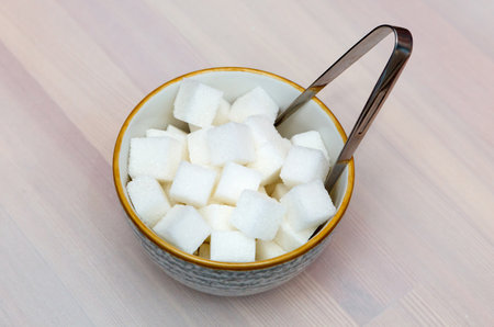 Cubes of white sugar in a sugar bowl. View from the top. Soft focus, selective focusの写真素材