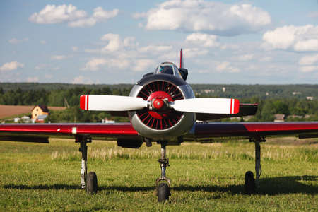 Propeller plane on the cloudy sky background