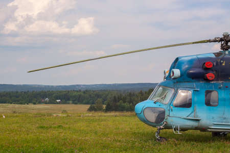 Blue helicopter on green grass of an aerodromeの写真素材
