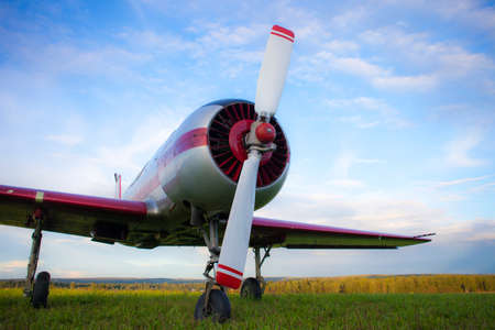 Propeller plane on the cloudy sky background. Photo taken from the bottom.