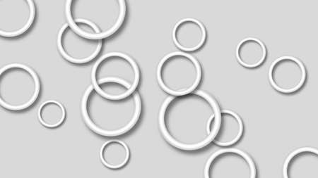 Abstract illustration of randomly arranged white rings with soft shadows on gray background