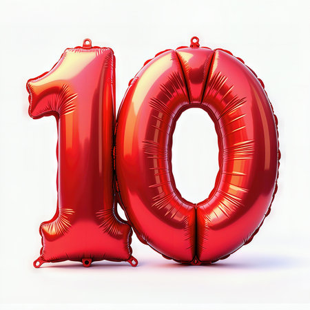 Birthday celebration with red foil balloons in the shape of the number 10 against a white background.の素材