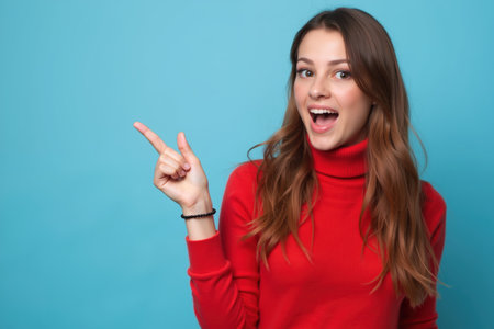 A cheerful woman with long hair wearing a red turtleneck sweater, pointing with her finger, against a blue background.の素材