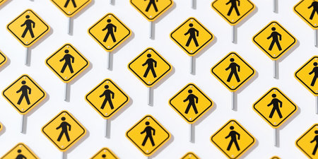 A repeating pattern of yellow and black pedestrian crossing signs is displayed at various angles on metal poles, with subtle shadow effects on a white background.の素材