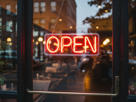 Open sign on the glass door of a cafe in the evening.の素材