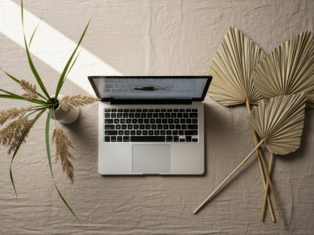 Laptop and pampas grass on the table. Flat lay.の素材