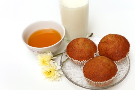 three cake on a plate and a glass of milkの写真素材