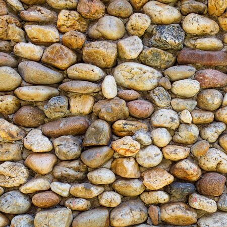 background made of a closeup of a wall with pebblesの写真素材