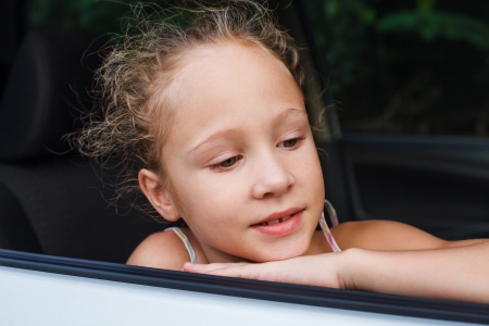 little girl  sitting in the carの写真素材