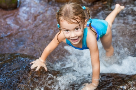 happy girl near the waterfallの写真素材