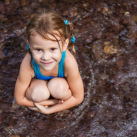happy girl near the waterfallの写真素材