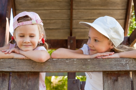 two happy  girls  on the playgroundの写真素材