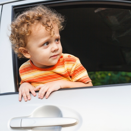 little boy sitting in the carの写真素材