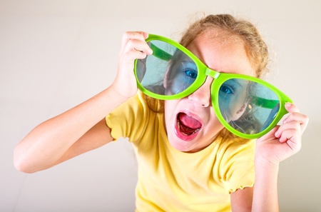 portrait of a little girl in big sunglassesの写真素材