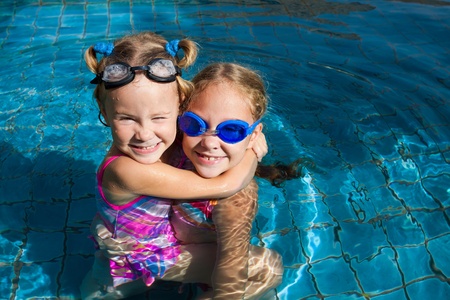 two little girls  playing in the pool