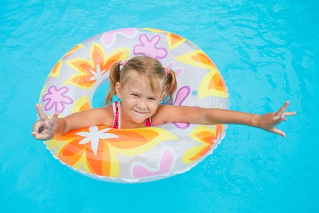 little girl in the pool  with rubber ring