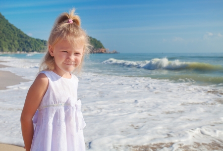 Adorable happy smiling girl on beach vacation の写真素材