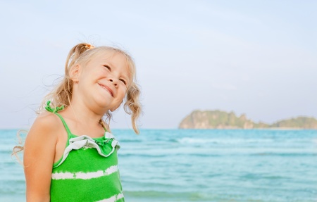 Adorable happy smiling girl on beach vacationの写真素材