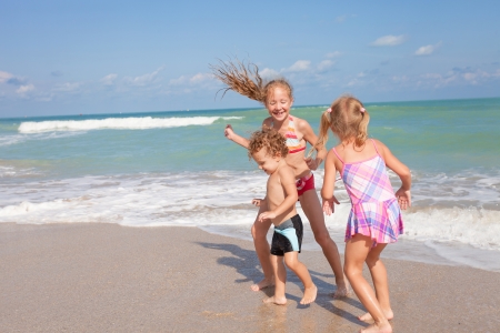 happy kids playing on beachの写真素材