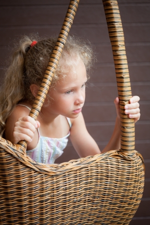 sad girl sitting on a chair の写真素材