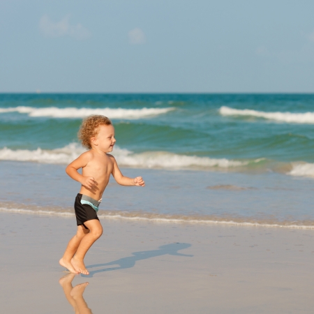 Little boy playing on the beach.の写真素材