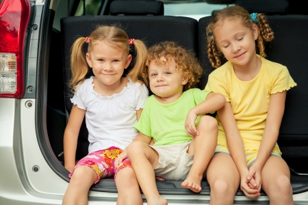 three happy kids in the carの写真素材
