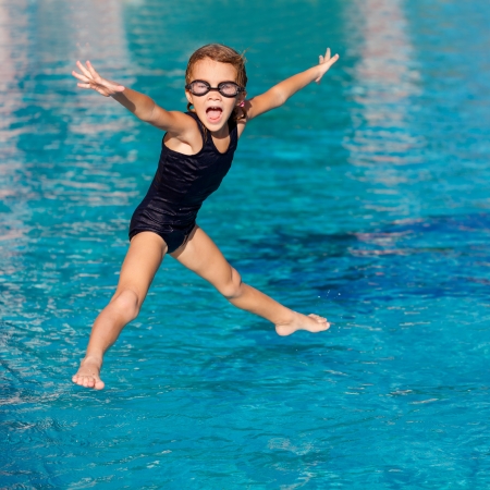 little girl playing in the swimming poolの写真素材