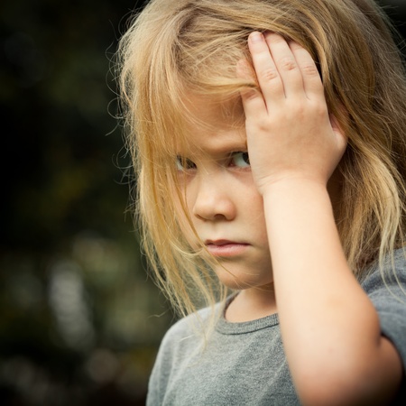 portrait of sad shaggy little girlの写真素材