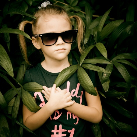 beautiful little girl in sunglasses and a black T-shirt that says  Daddy の写真素材
