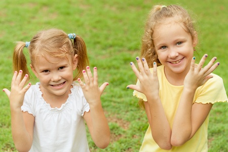 two happy little girls in the parkの写真素材