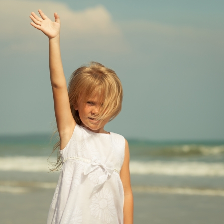 happy little  girl standing  on the  beach の写真素材