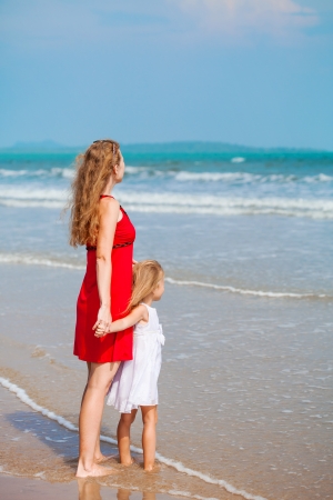 Mother with her little daughter on the beach の写真素材