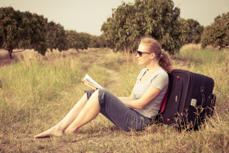 woman sitting reading a book on natureの写真素材