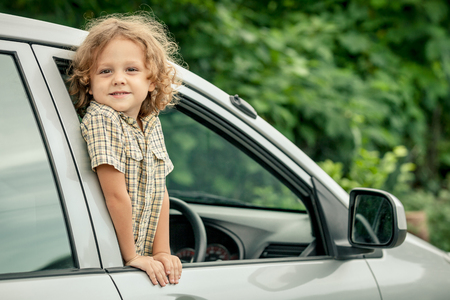 Portrait of a  little boy who sitting in the carの写真素材