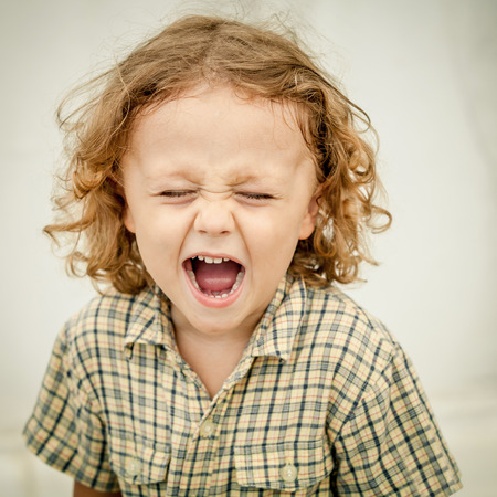 Portrait of a screaming little boyの写真素材