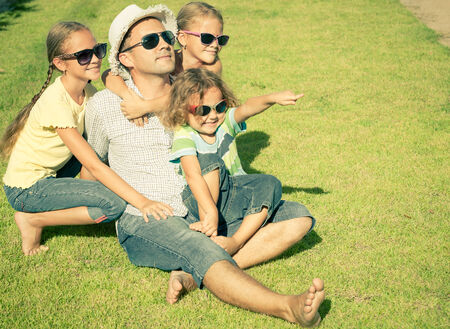 Portrait a happy family sitting on the grass at the day timeの写真素材