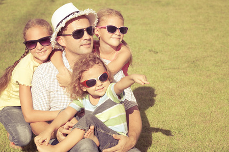 Portrait a happy family sitting on the grass at the day timeの写真素材