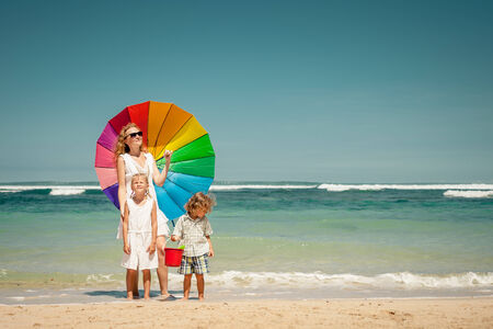 Happy family walking on the beach at the day timeの写真素材