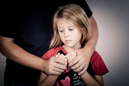 portrait of one sad daughter hugging her fatherの写真素材