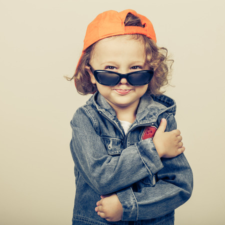 Fashion child. Happy boy model. Stylish little boy in baseball.  Handsome  kid  in the jeans jacket.の写真素材