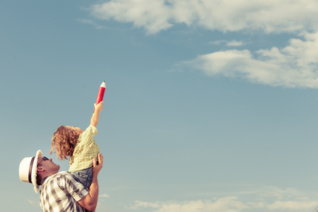Dad and son playing near a house at the day timeの写真素材