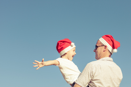 Father and little son playing near a house at the day time. Concept of friendly family.の写真素材